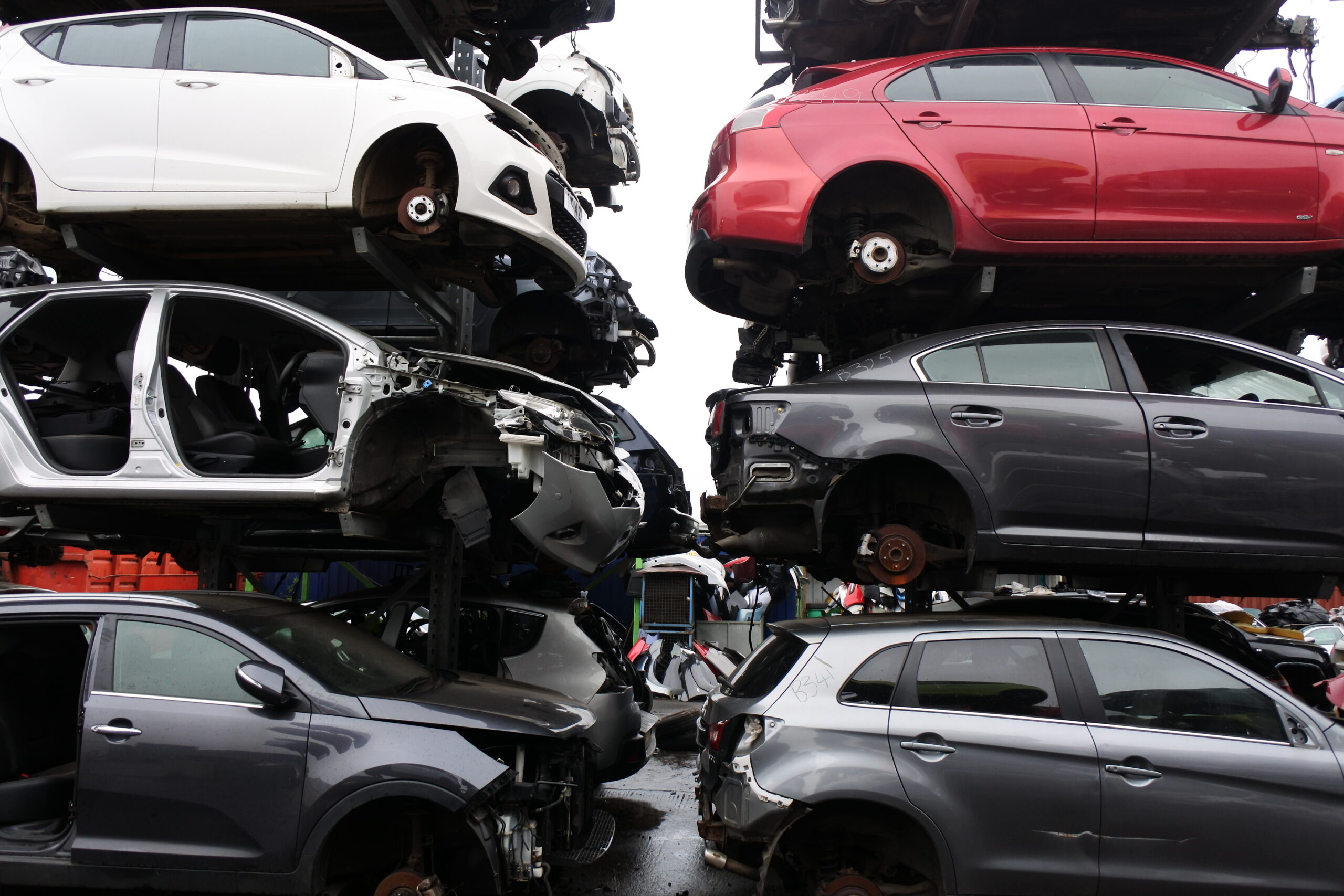 Photo of scrap car shells on racking