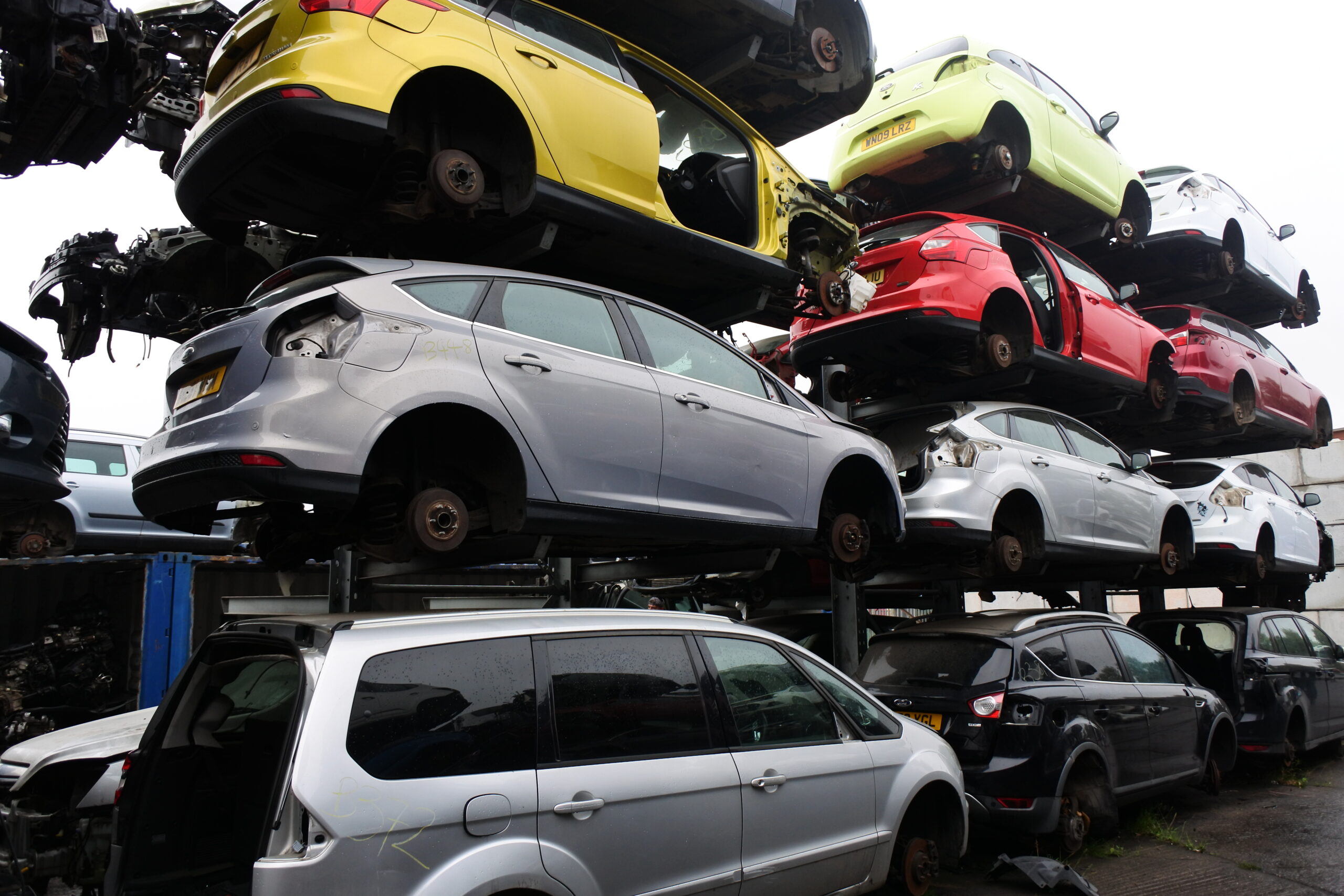 Photo of scrap car shells on racking