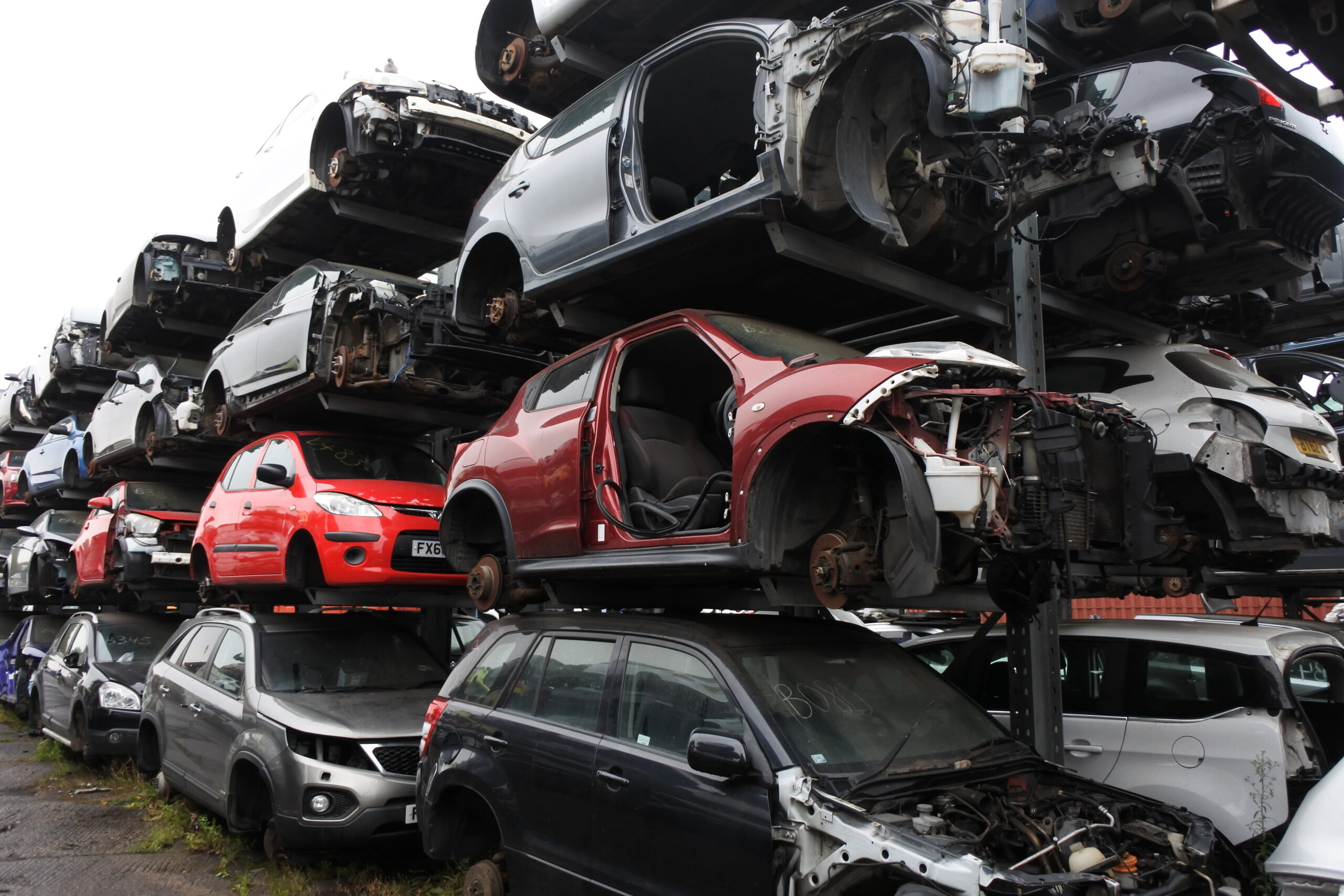 Photo of scrap car shells on racking