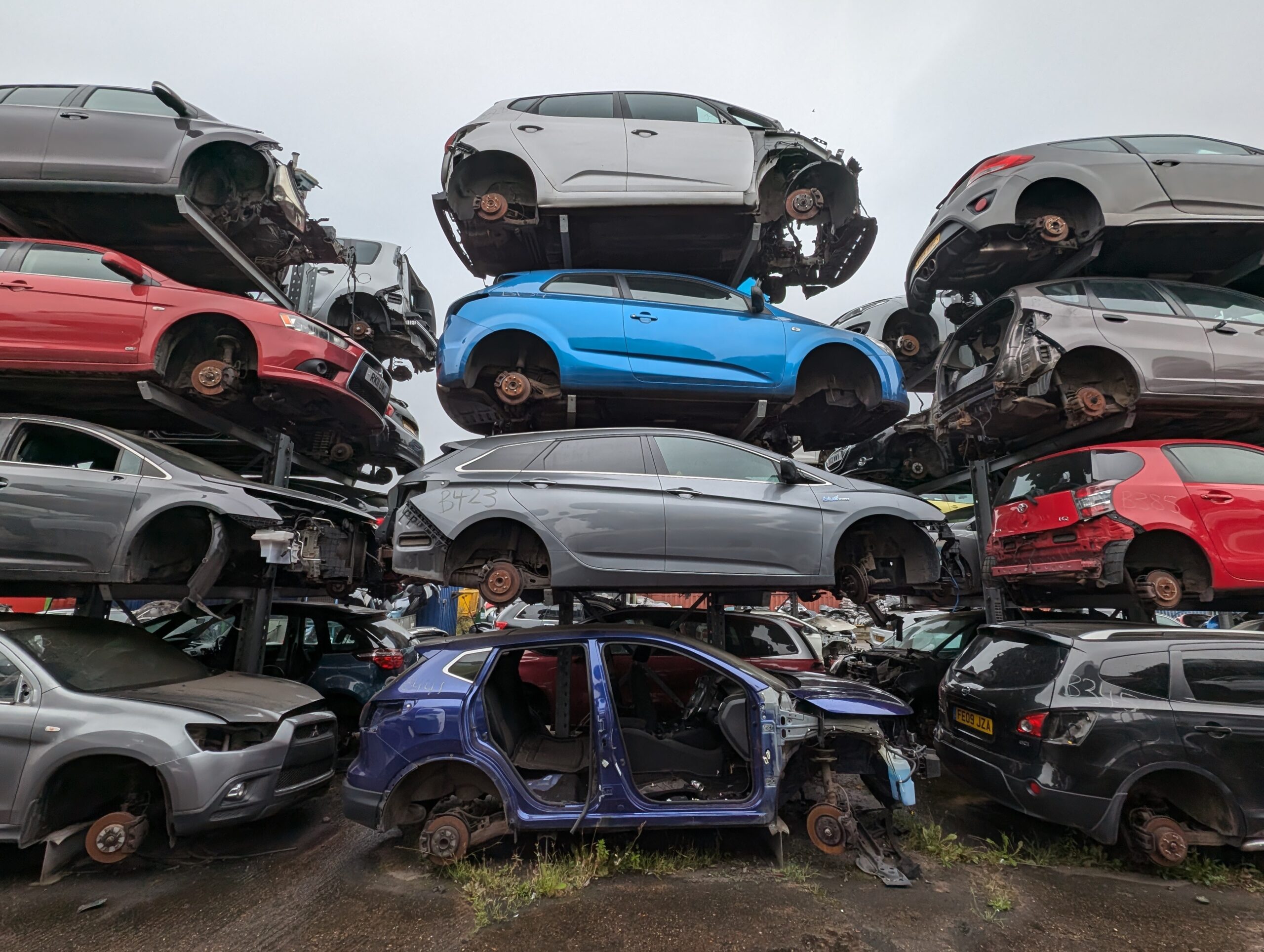 Photo of scrap car shells on racking