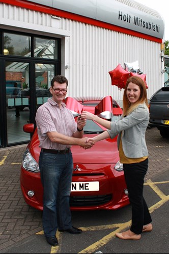 Competition winner Brian with their new red Mitsubishi