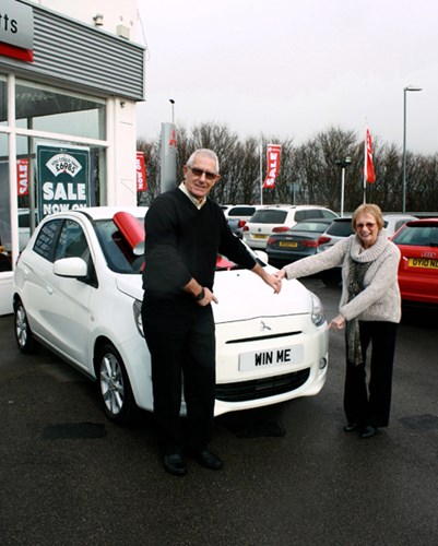Compeition winners Jim and Maureen with their new white Mitsubishi
