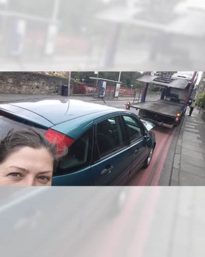 Selfie of a customer smiling with their old car