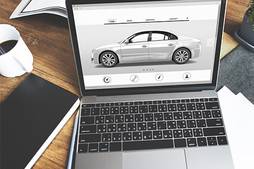 Laptop with online car sales website