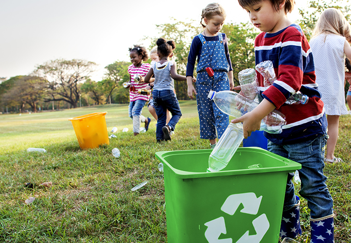 Group of kids school recycling bottles