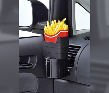 French fires in a red box slotted into a bespoke holder on a car dashboard