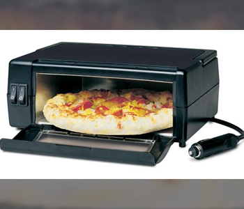 Pizza in a small oven which has a power cord to be plugged into a car