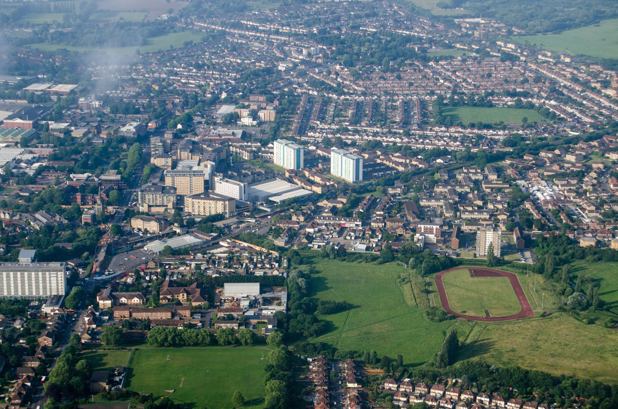 Aerial view of the Feltham district of the London Borough of Hounslow in West London. A mainly residential area, there are large supermarkets a railway line into central London and the Glebelands playing fields with athletics track.