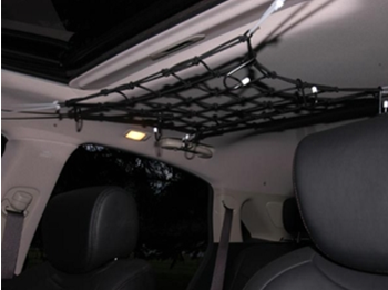 Cargo net stretched across car roof interior