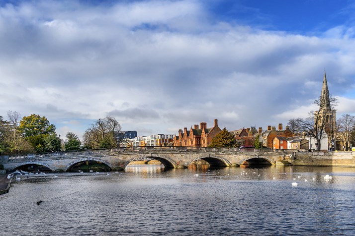 Photo of townin Bedfordshire, a river, bridge, houses and church