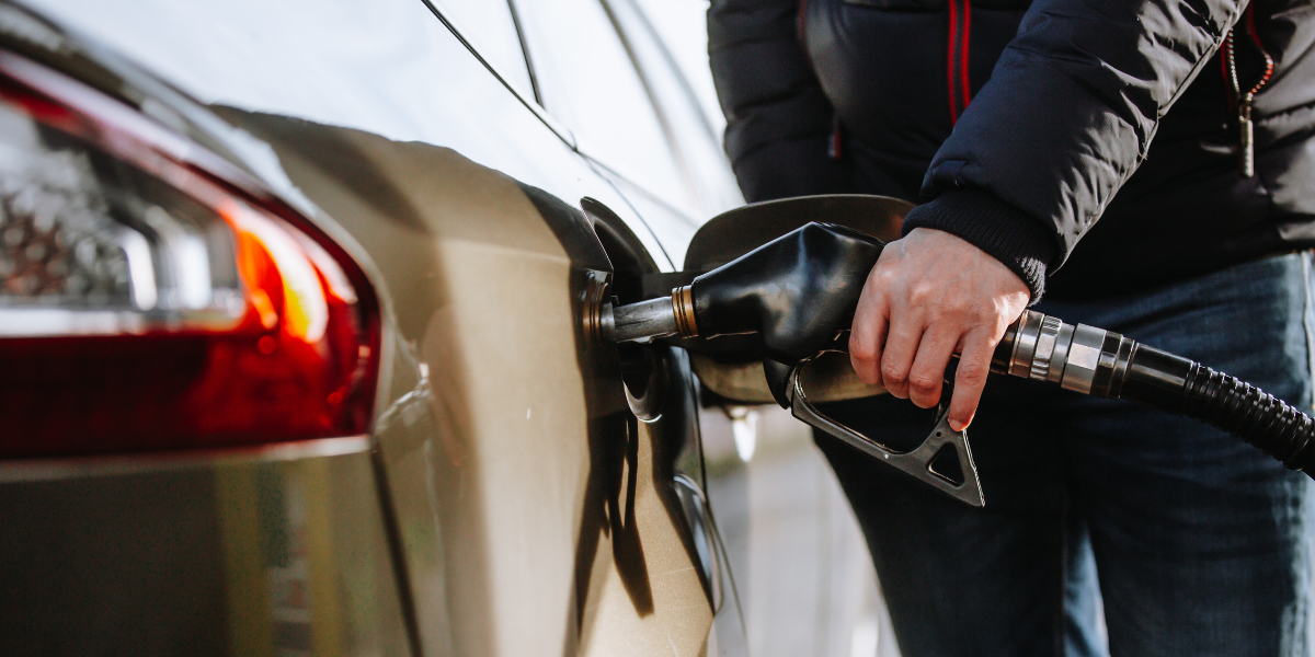 Photo of hand holding diesel fuel pump, filling car